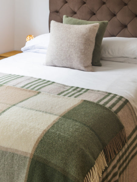 Block Check and Hex Olive Blankets on a bed